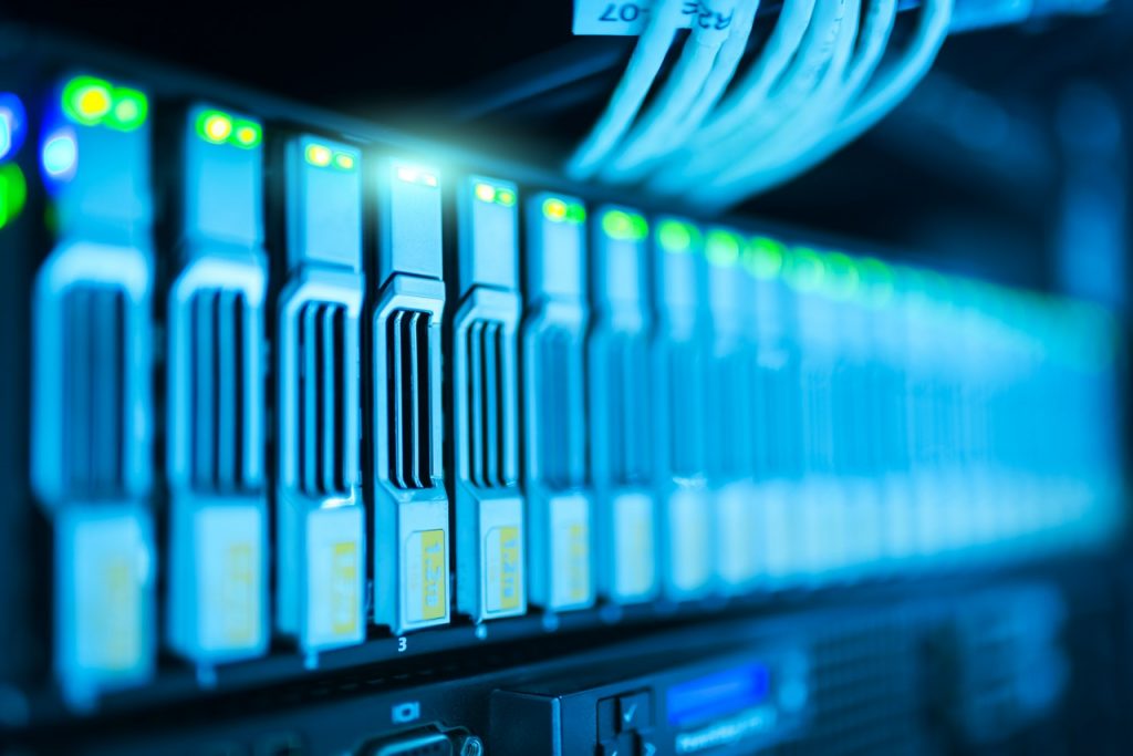 Rows of hard drives neatly arranged in a server rack, reflecting our commitment to cybersecurity through advanced data storage and management