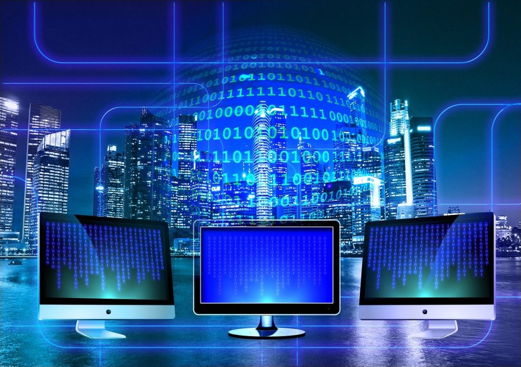 Binary code blending with a city skyline, accompanied by three iMacs, symbolizing our commitment to Enterprise relation system (ERP).